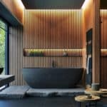 Salle de bains moderne avec boiseries murales, baignoire autoportante noire, miroir circulaire et grandes fenêtres. Cette chambre dispose de plantes d'intérieur, d'un espace douche et d'une décoration minimaliste.