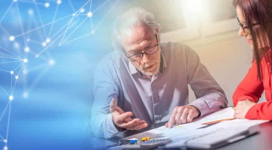 Un Homme âgé Et Une Femme Sont Assis à Une Table Et Discutent De Documents, Avec Un Graphique De Réseau Numérique Bleu Sur Le Côté Gauche De L'image.