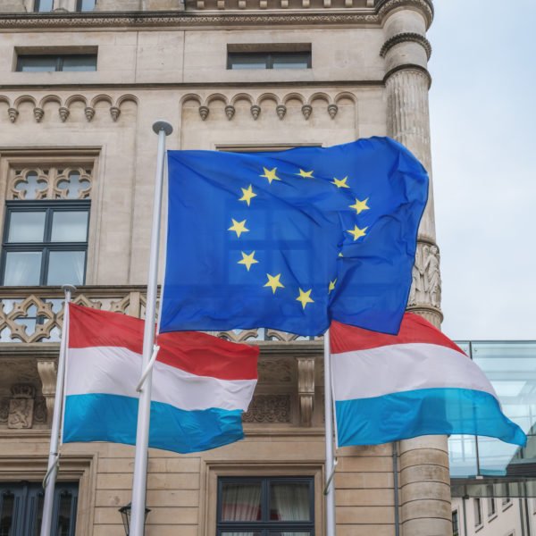 European Union And Luxembourg Flags Waving In Front Of The Chamb